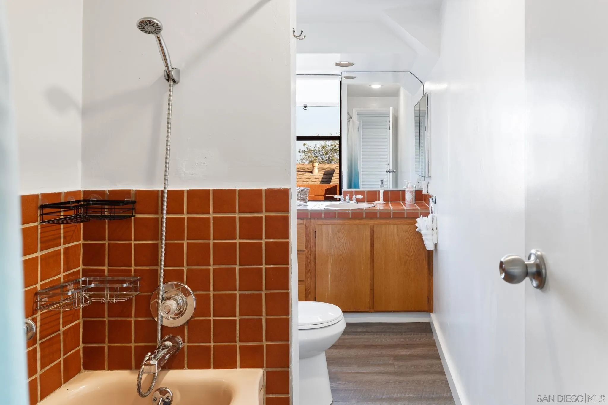 5643 Linda Rosa Avenue La Jolla, CA 92037 - Photo 23 of 56 a bathroom with a sink a toilet a mirror and shower