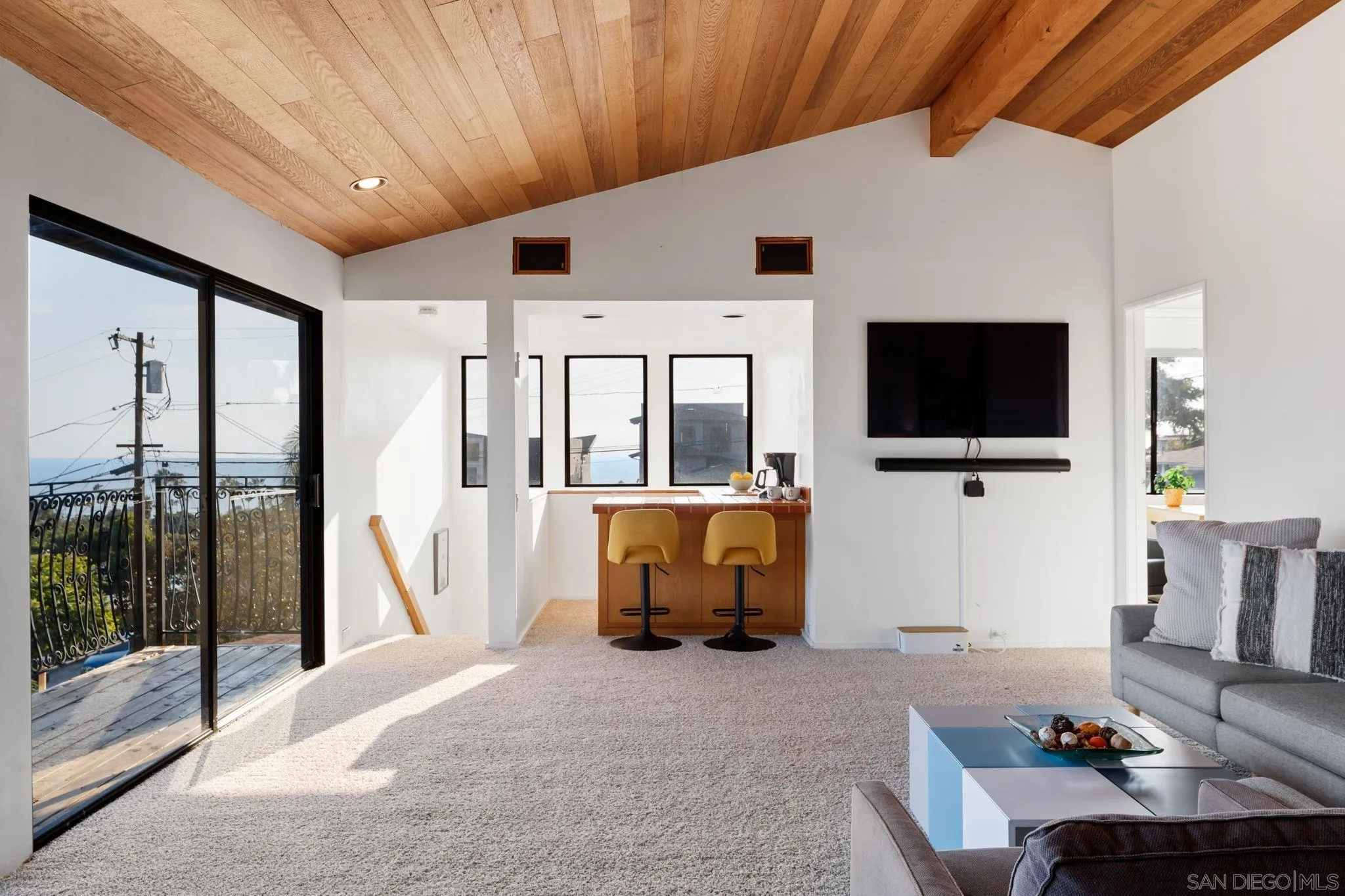 5643 Linda Rosa Avenue La Jolla, CA 92037 - Photo 24 of 56 a living room with furniture and a flat screen tv