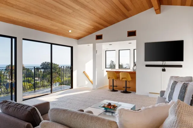 a view of a workspace with furniture and a flat screen tv