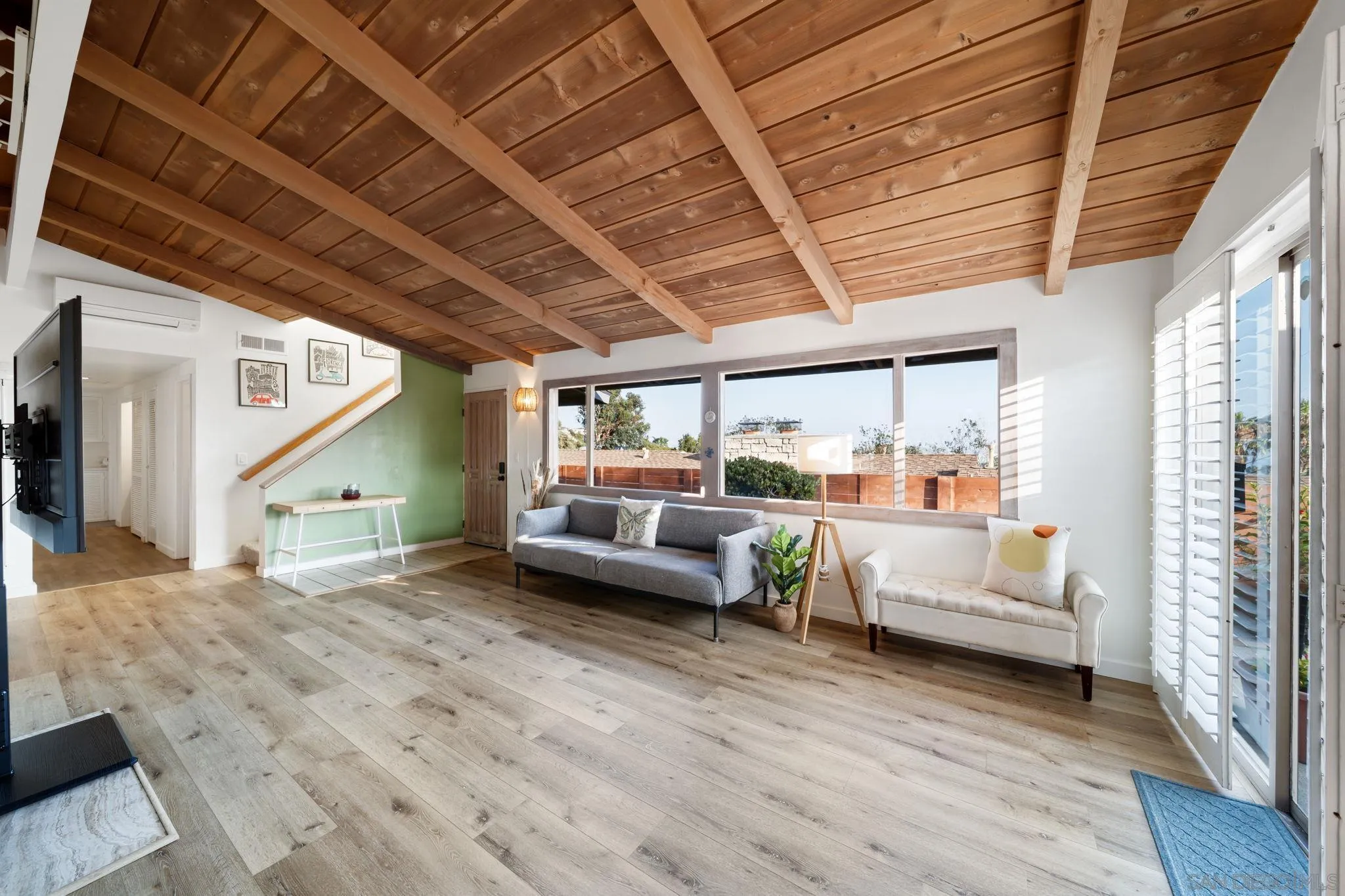 5643 Linda Rosa Avenue La Jolla, CA 92037 - Photo 32 of 56 a living room with furniture and a large window