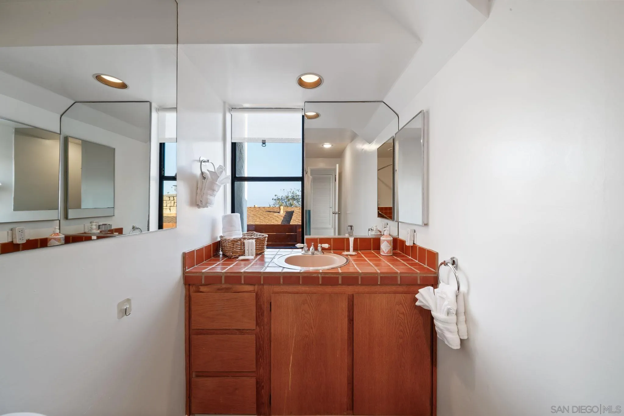 5643 Linda Rosa Avenue La Jolla, CA 92037 - Photo 36 of 56 a bathroom with a sink vanity and a mirror