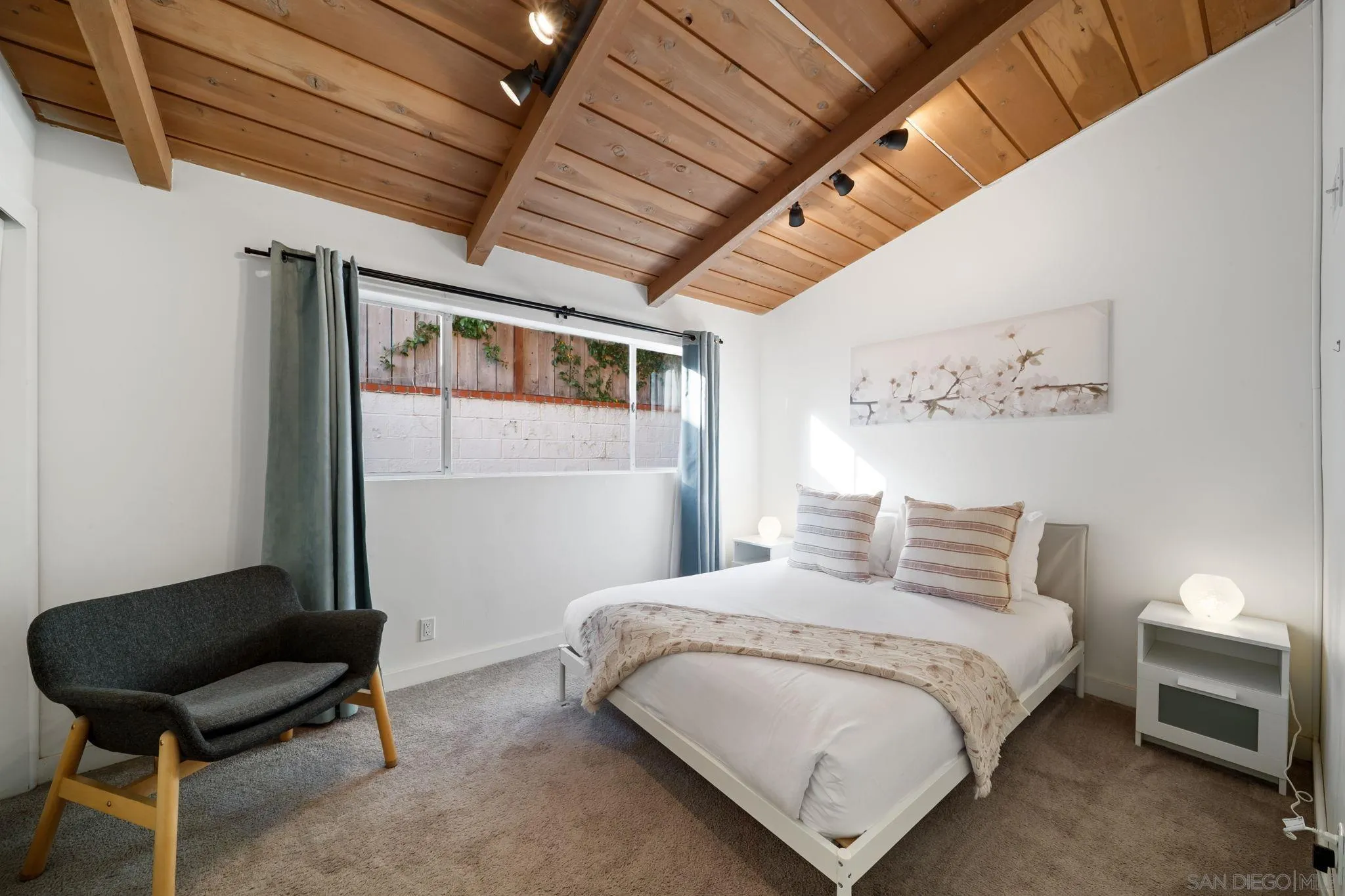 5643 Linda Rosa Avenue La Jolla, CA 92037 - Photo 37 of 56 a bedroom with a bed chair and a window