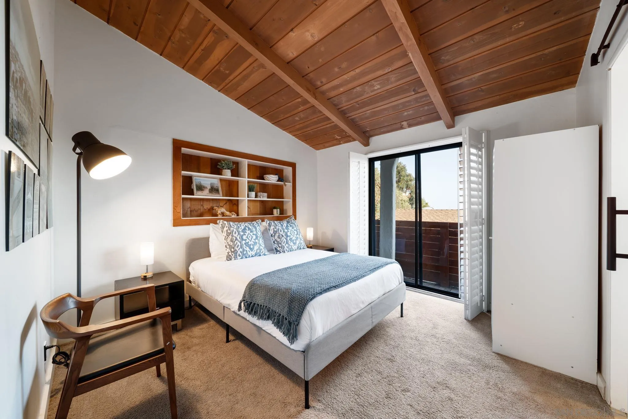 5643 Linda Rosa Avenue La Jolla, CA 92037 - Photo 39 of 56 a bedroom with a bed lamp and a large window