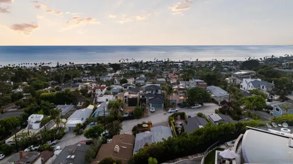 an aerial view of a house with swimming pool and porch