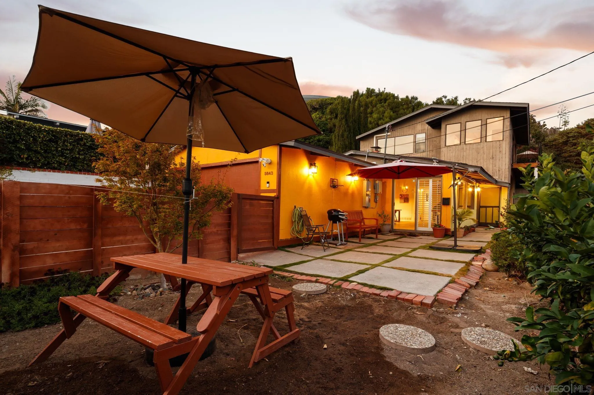 5643 Linda Rosa Avenue La Jolla, CA 92037 - Photo 6 of 56 a view of a patio with table and chairs under an umbrella
