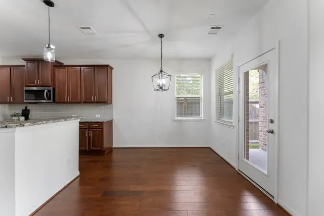 a view of a kitchen with a sink dishwasher and wooden floor