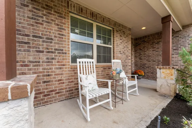a balcony with table and chairs