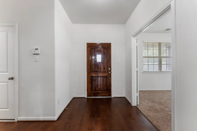 an empty room with wooden floor and closet