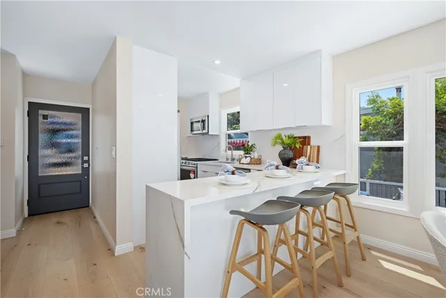 a view of a dining table chairs and chandelier