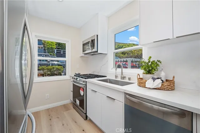 a kitchen with a sink cabinets and window