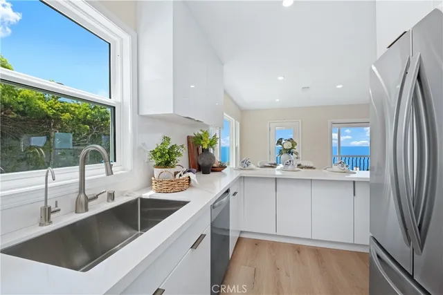 a kitchen with a sink and a refrigerator