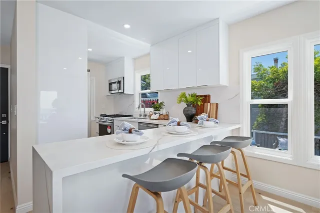 a kitchen with a table chairs and a refrigerator