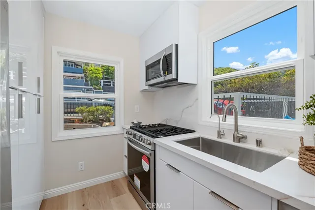 a kitchen that has a sink and a stove