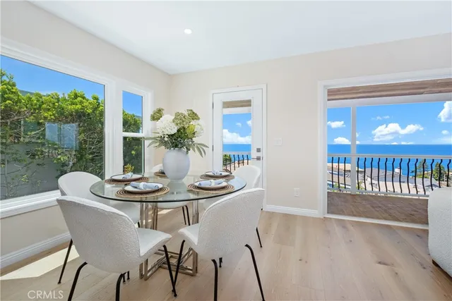 a view of a dining room with furniture window and wooden floor