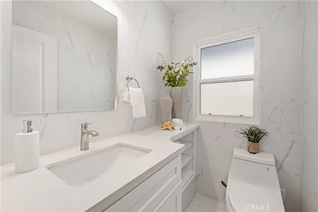 a bathroom with a sink toilet and vanity