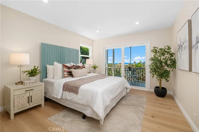 a spacious bedroom with a bed and a potted plant