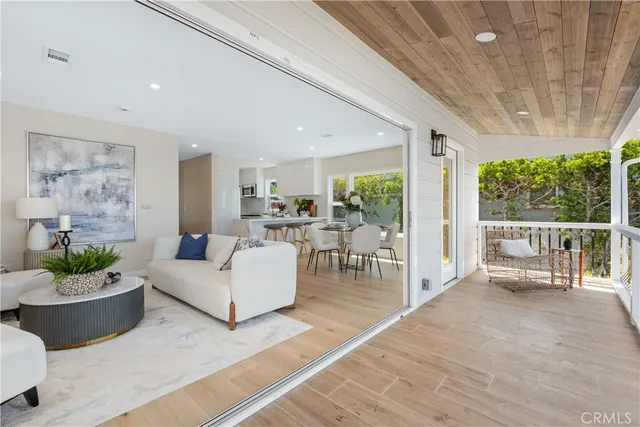 a living room with furniture potted plant and a large window