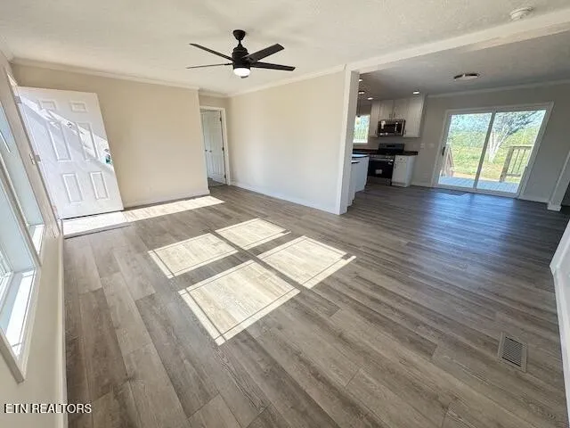 a view of livingroom with kitchen and wooden floor