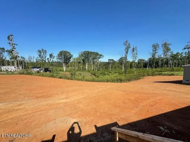 a view of balcony with wooden floor and lake view