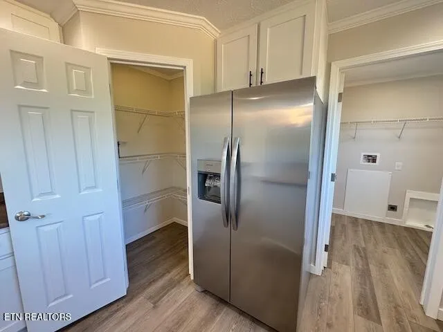 a view of a refrigerator in kitchen and wooden floor