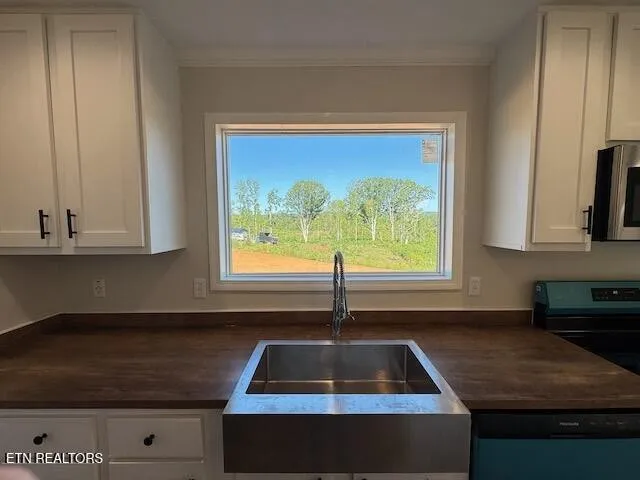 a kitchen with appliances a sink and a stove