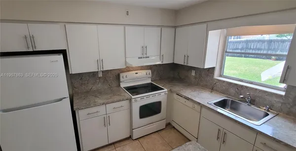 a kitchen with appliances cabinets and a sink