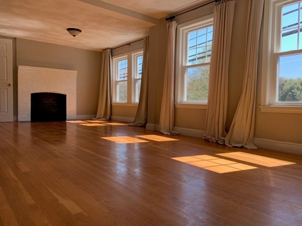 a view of livingroom with window fireplace and hardwood floor