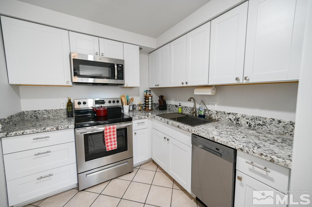 340 West Hampton Drive Carson City, NV 89706 - Photo 14 of 24 a kitchen with stainless steel appliances granite countertop white cabinets sink and stove