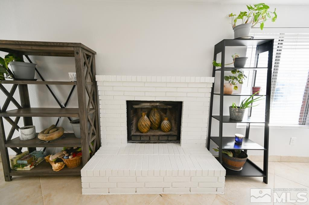 340 West Hampton Drive Carson City, NV 89706 - Photo 9 of 24 a bedroom with a bed a table and potted plant