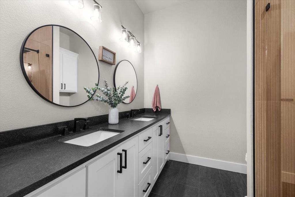 1059 Sweeney Way Weatherford, TX 76087 - Photo 20 of 37 Full bathroom featuring a dual vanity with granite countertops.