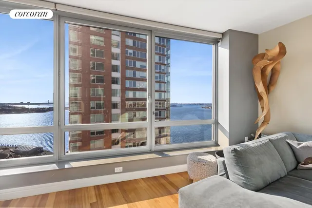 a living room with furniture and a floor to ceiling window