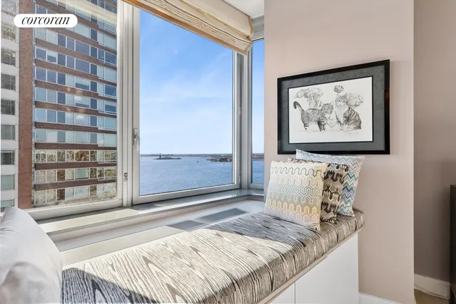 a view of a bedroom with a bed and a window