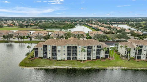 an aerial view of residential houses with outdoor space and lake view