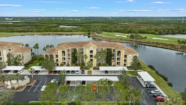 an aerial view of residential houses with outdoor space and ocean view
