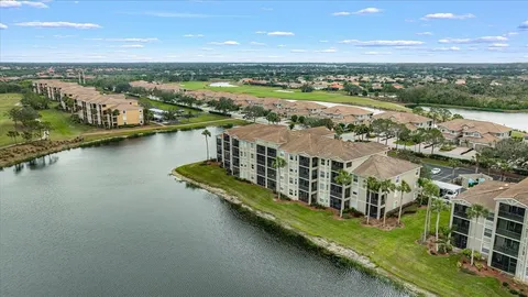 an aerial view of residential building with outdoor space lake view and mountain view
