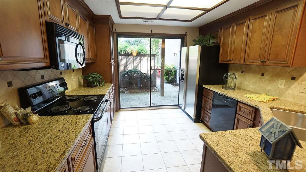 4301 Sun Belt Place Raleigh, NC 27613 - Photo 11 of 23 Kitchen Designed for Food and Fun Together. Sliding Glass Door overlooks Front Patio