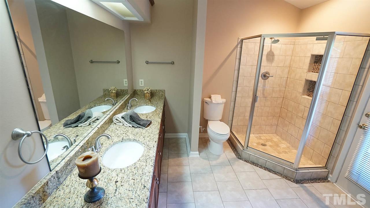 4301 Sun Belt Place Raleigh, NC 27613 - Photo 15 of 23 Spa-like Master Bath has an Updated, Mirrored Double Vanity with Granite Countertop + Walk-in Closet + Walk-out Balcony