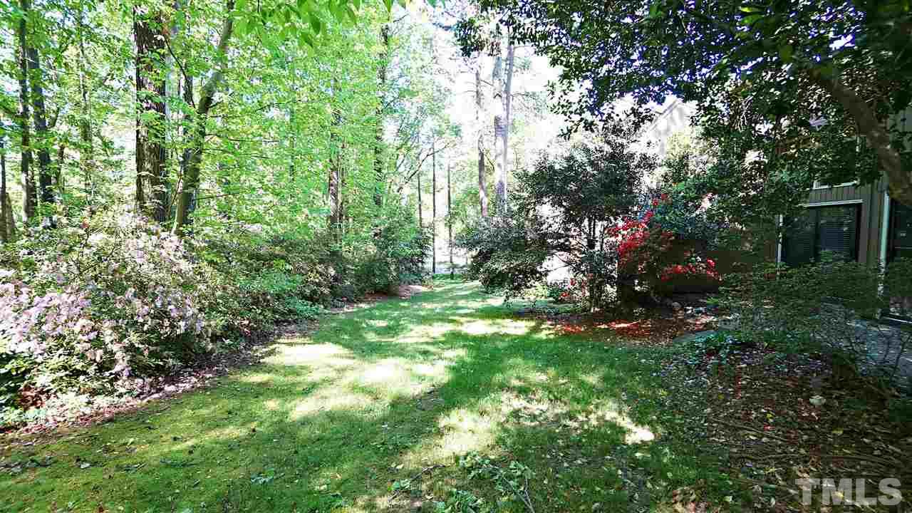 4301 Sun Belt Place Raleigh, NC 27613 - Photo 22 of 23 Park-like Setting complete with Mature Trees and Flowering Landscaping creates a Backyard Oasis