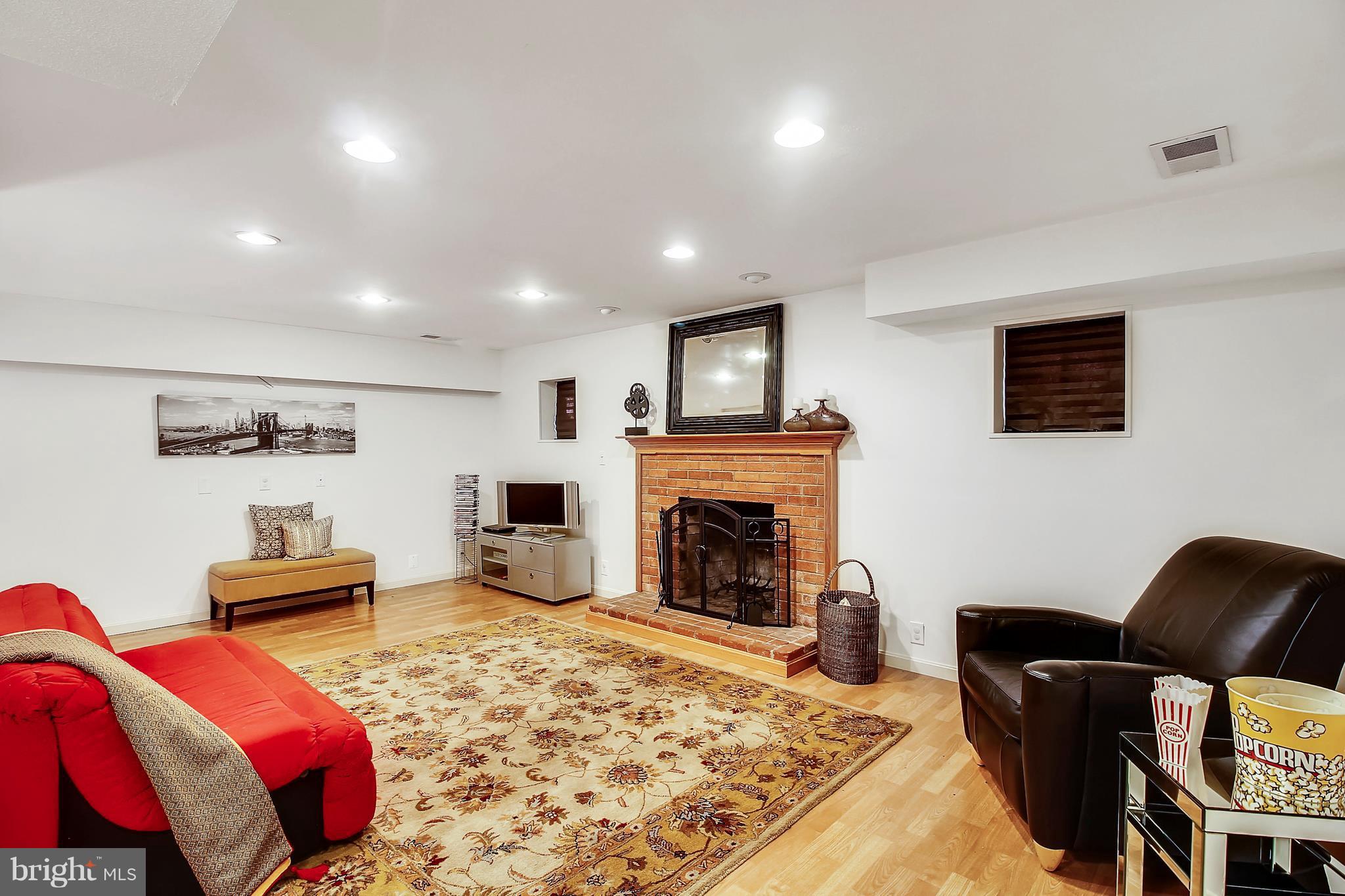 11501 Alma Street Silver Spring, MD 20902 - Photo 26 of 29 Recreation Room with fireplace and Pergo wood floo