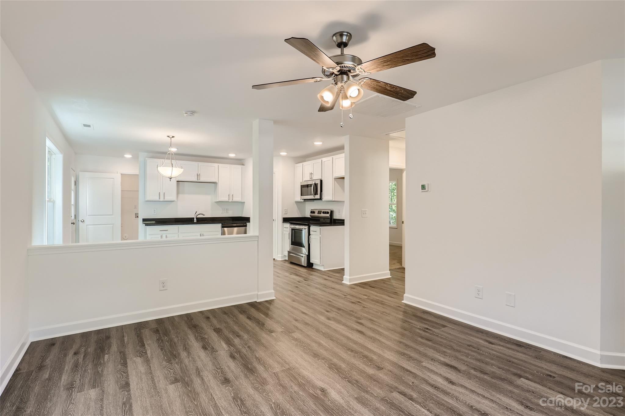 626 Colston Street Albemarle, NC 28001 - Photo 2 of 11 a view of a kitchen with wooden floor and a kitchen