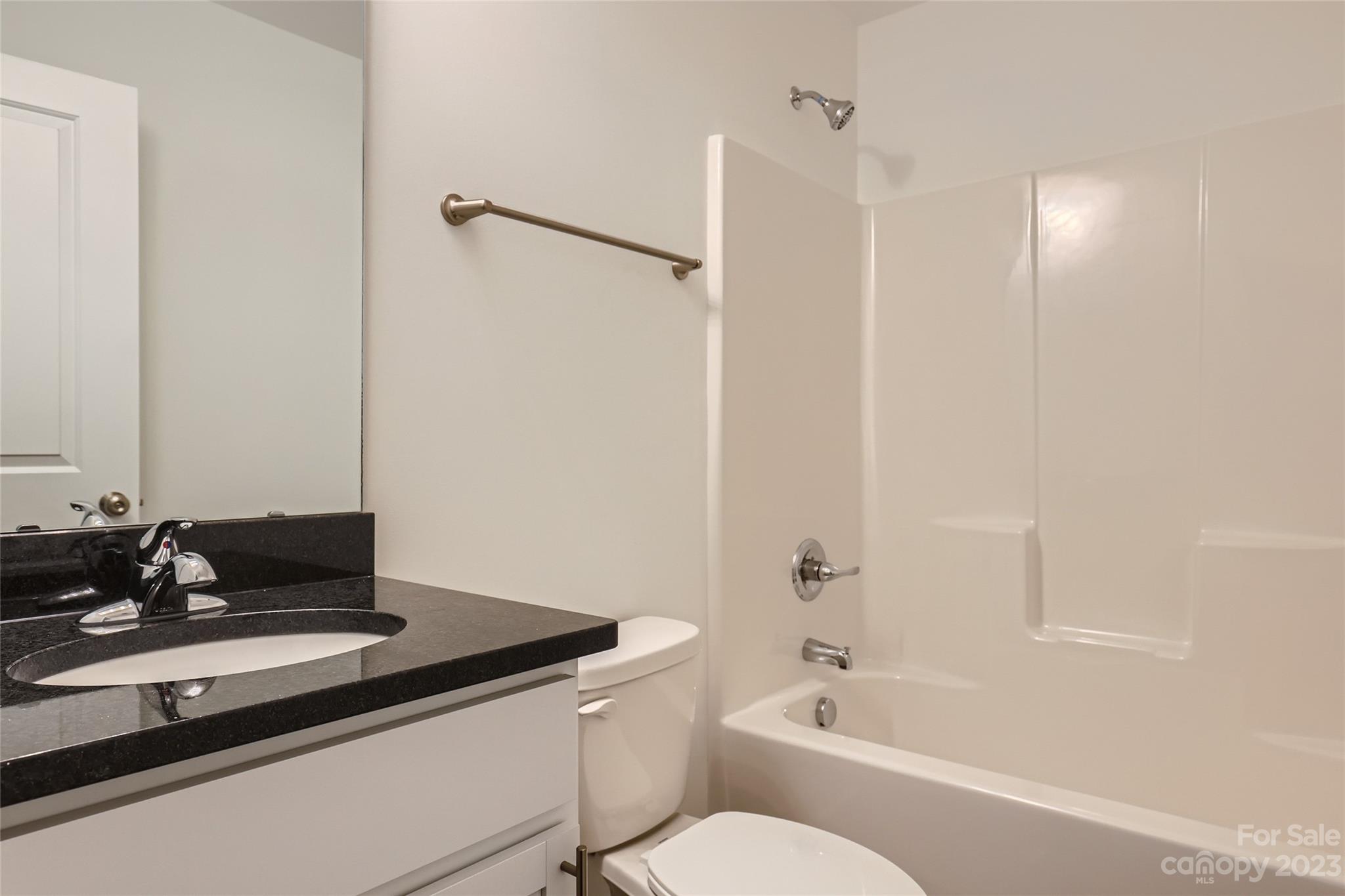 626 Colston Street Albemarle, NC 28001 - Photo 8 of 11 a bathroom with a granite countertop sink a toilet and shower