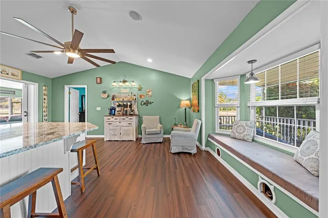 a kitchen with stainless steel appliances kitchen island granite countertop a sink and cabinets