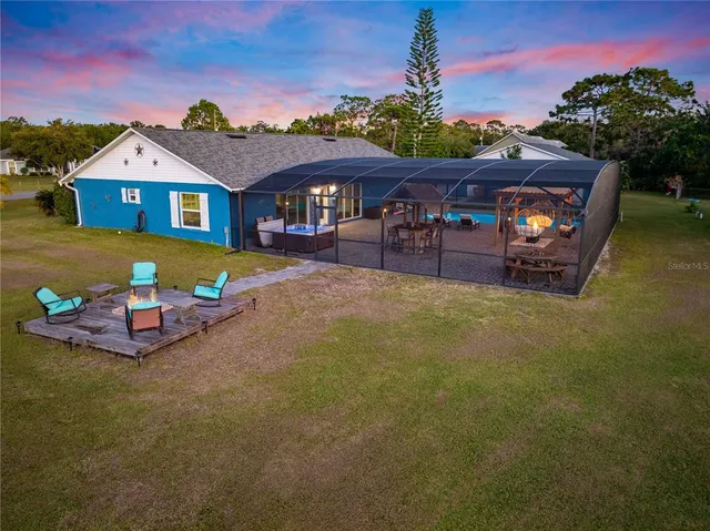 a kitchen with stainless steel appliances a kitchen island hardwood floor and a sink