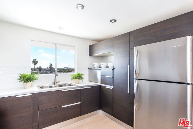 a kitchen with a refrigerator and a sink