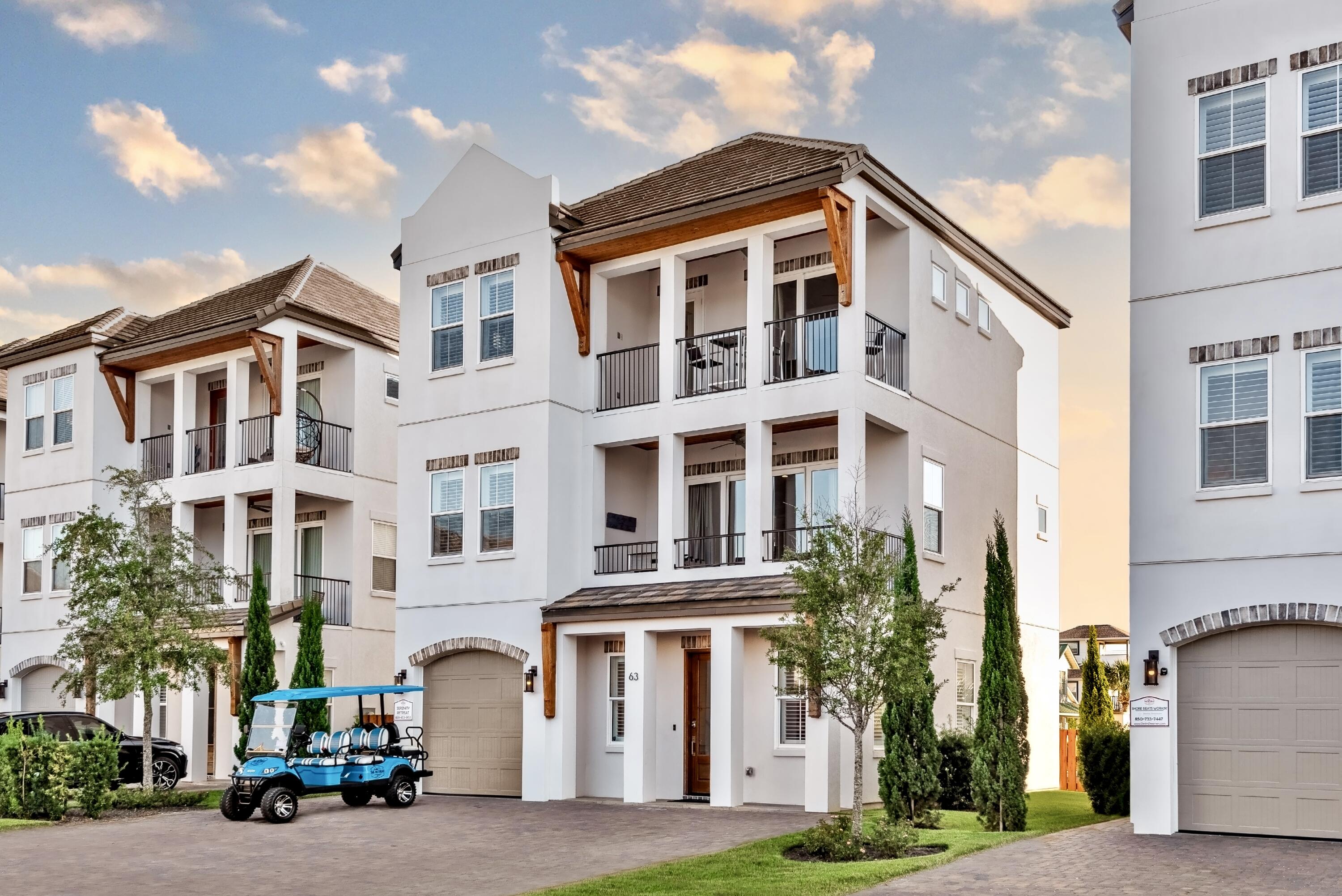 a front view of a residential apartment building with a yard
