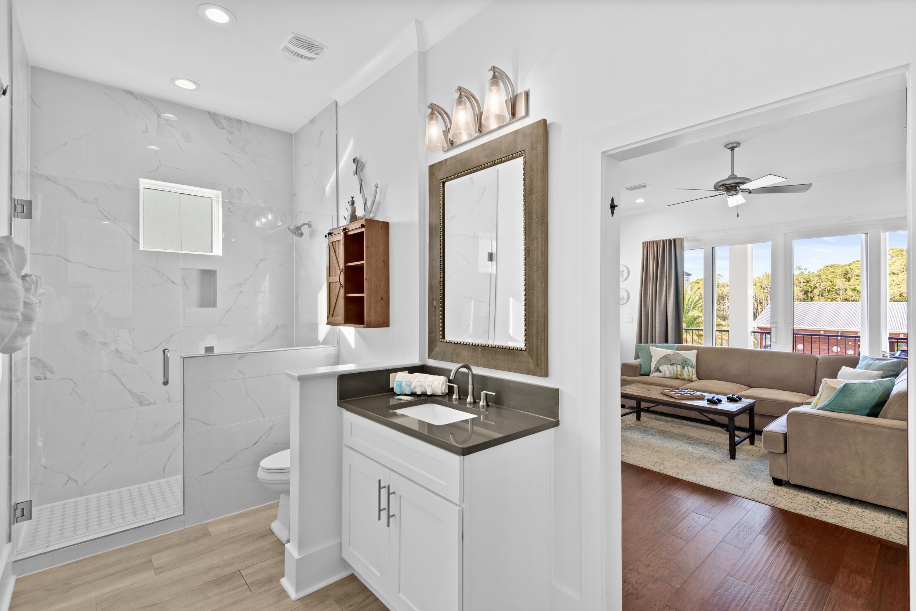 63 Wadleigh Way Miramar Beach, FL 32550 - Photo 20 of 42 a spacious bathroom with a granite countertop tub sink and mirror