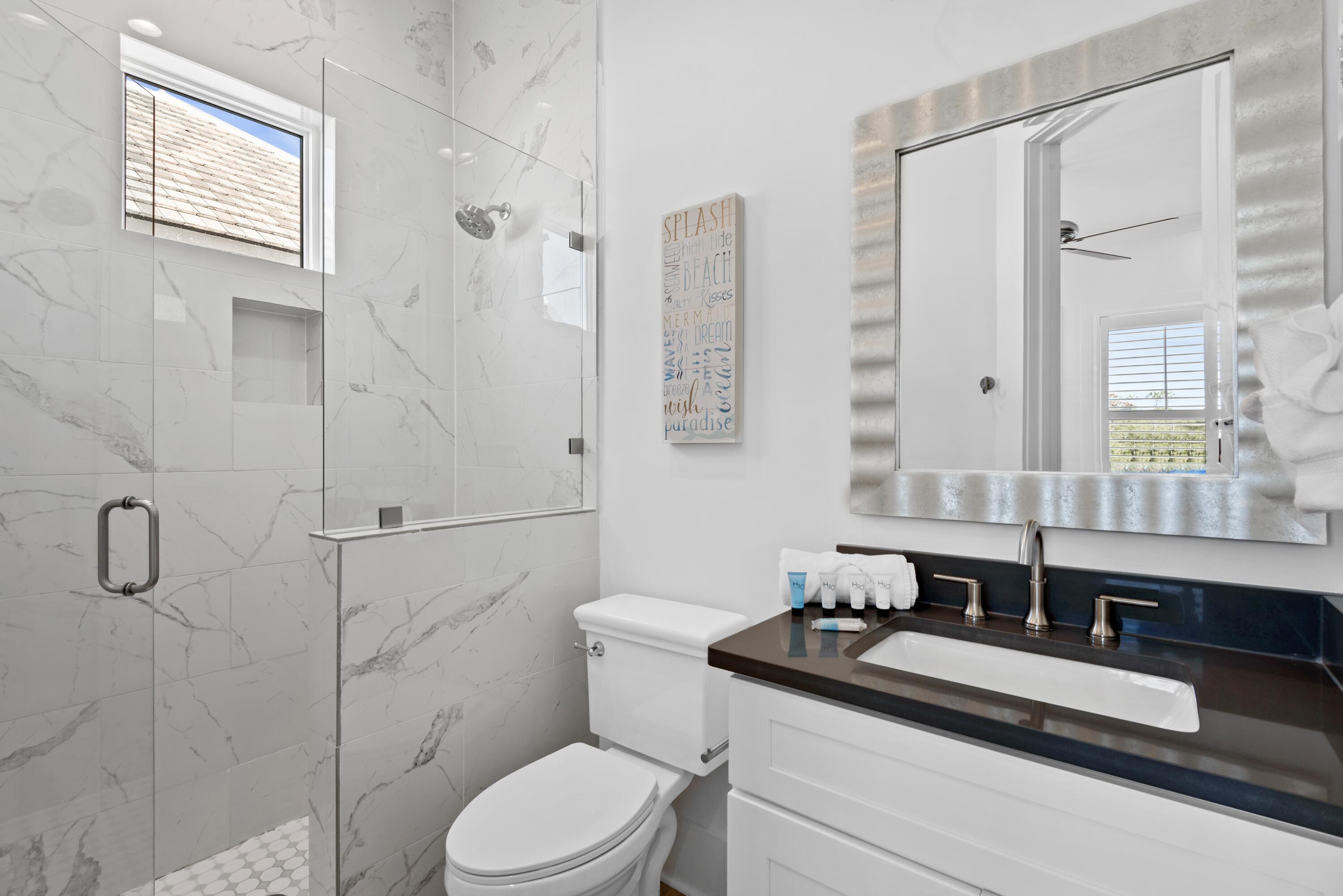 63 Wadleigh Way Miramar Beach, FL 32550 - Photo 27 of 42 a bathroom with a granite countertop sink mirror toilet and shower