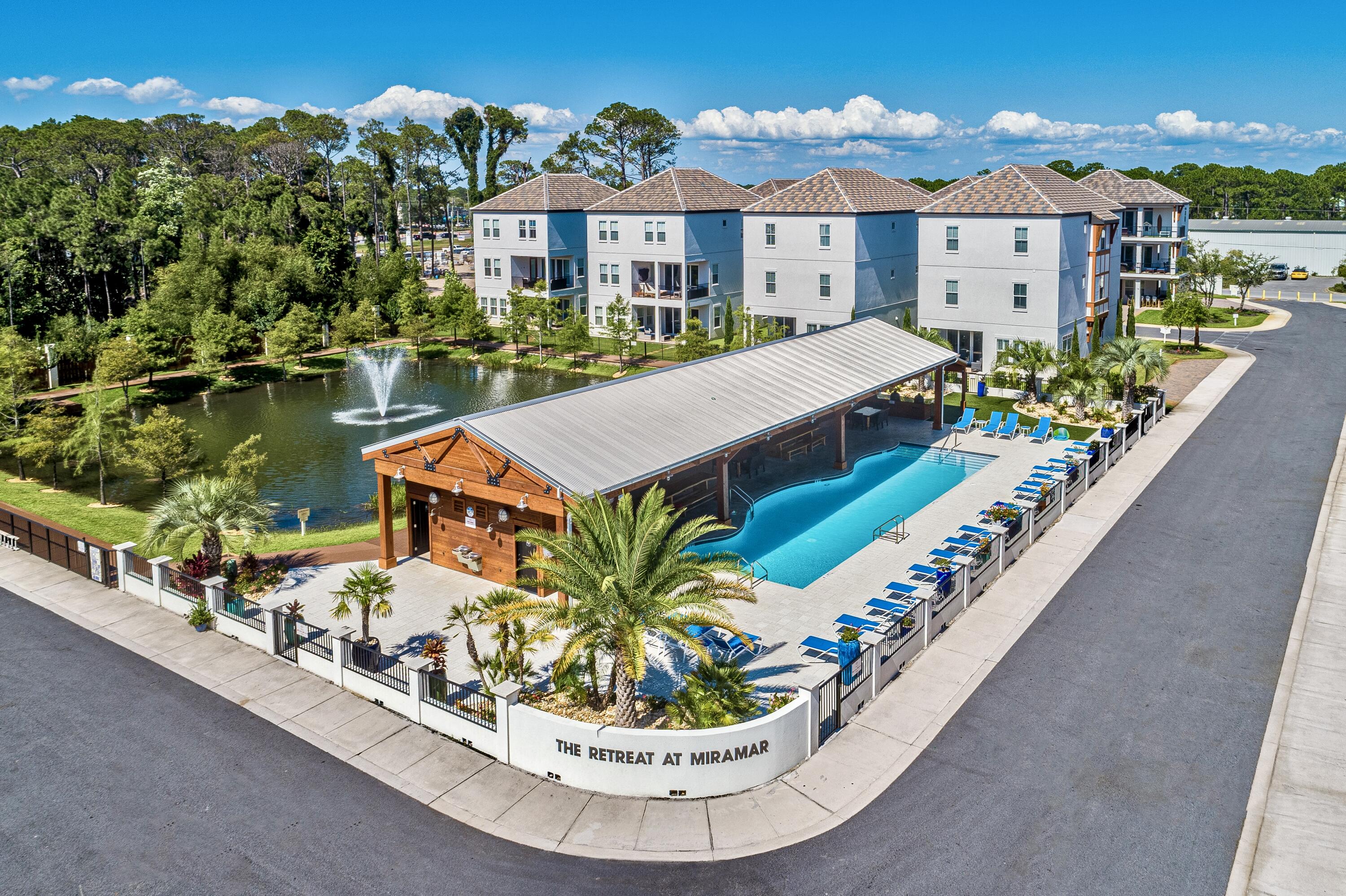 63 Wadleigh Way Miramar Beach, FL 32550 - Photo 31 of 42 a view of a house with a chairs and table in a patio