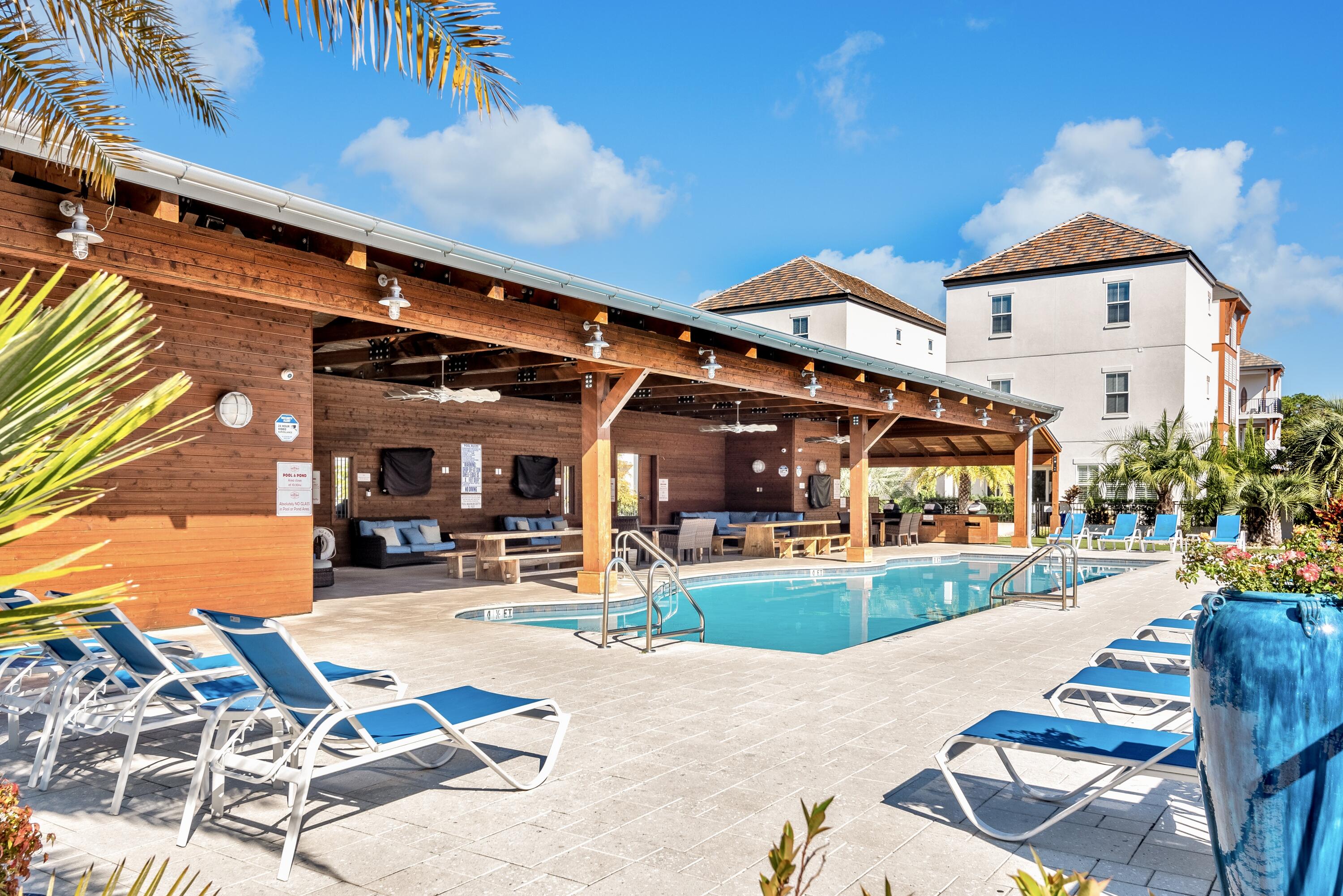 63 Wadleigh Way Miramar Beach, FL 32550 - Photo 33 of 42 a view of a patio with a table and chairs and potted plants