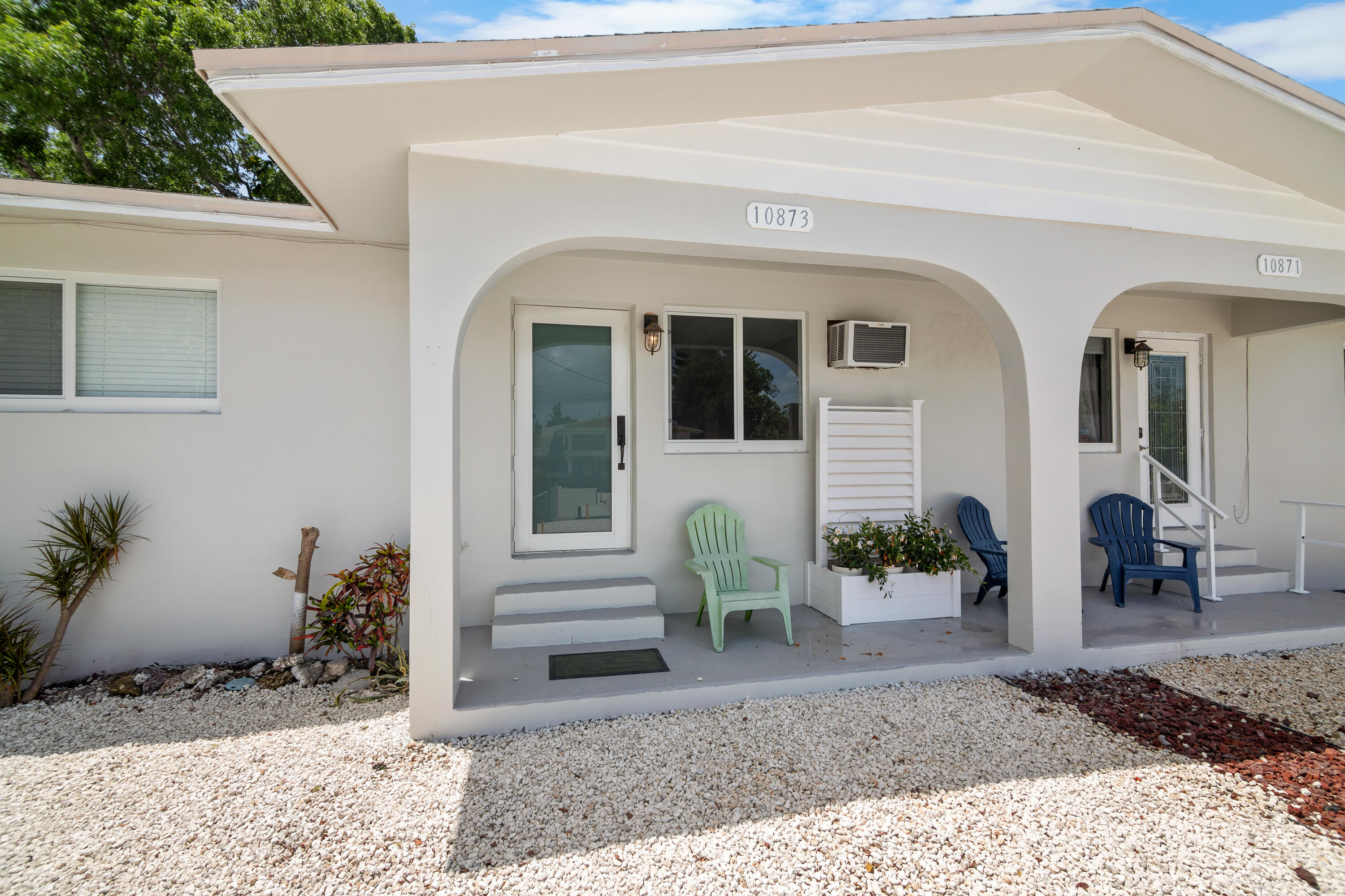 a view of a house with a yard and sitting area